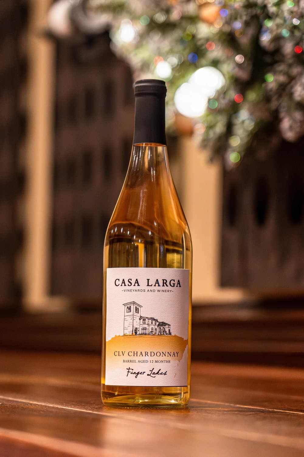 A bottle of CLV Barrel Aged Chardonnay on a wooden bar