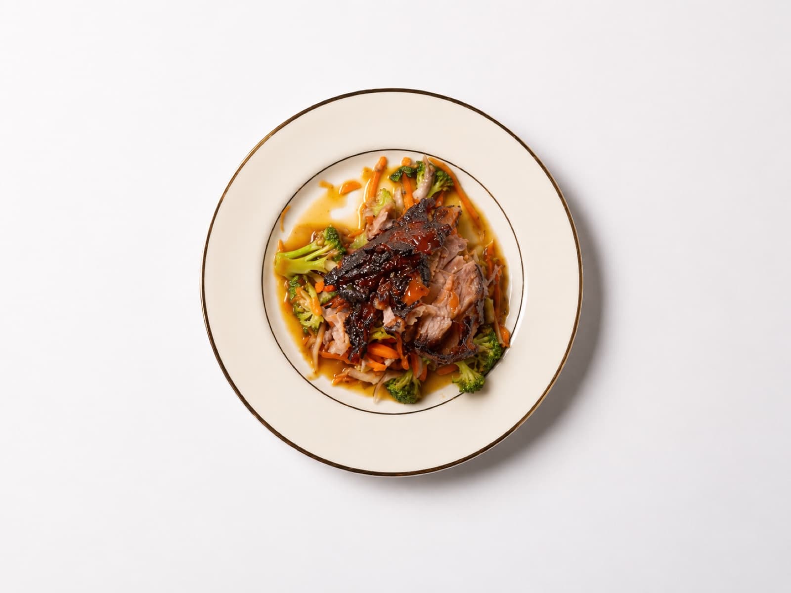Braised beef plated with seasonal vegetables