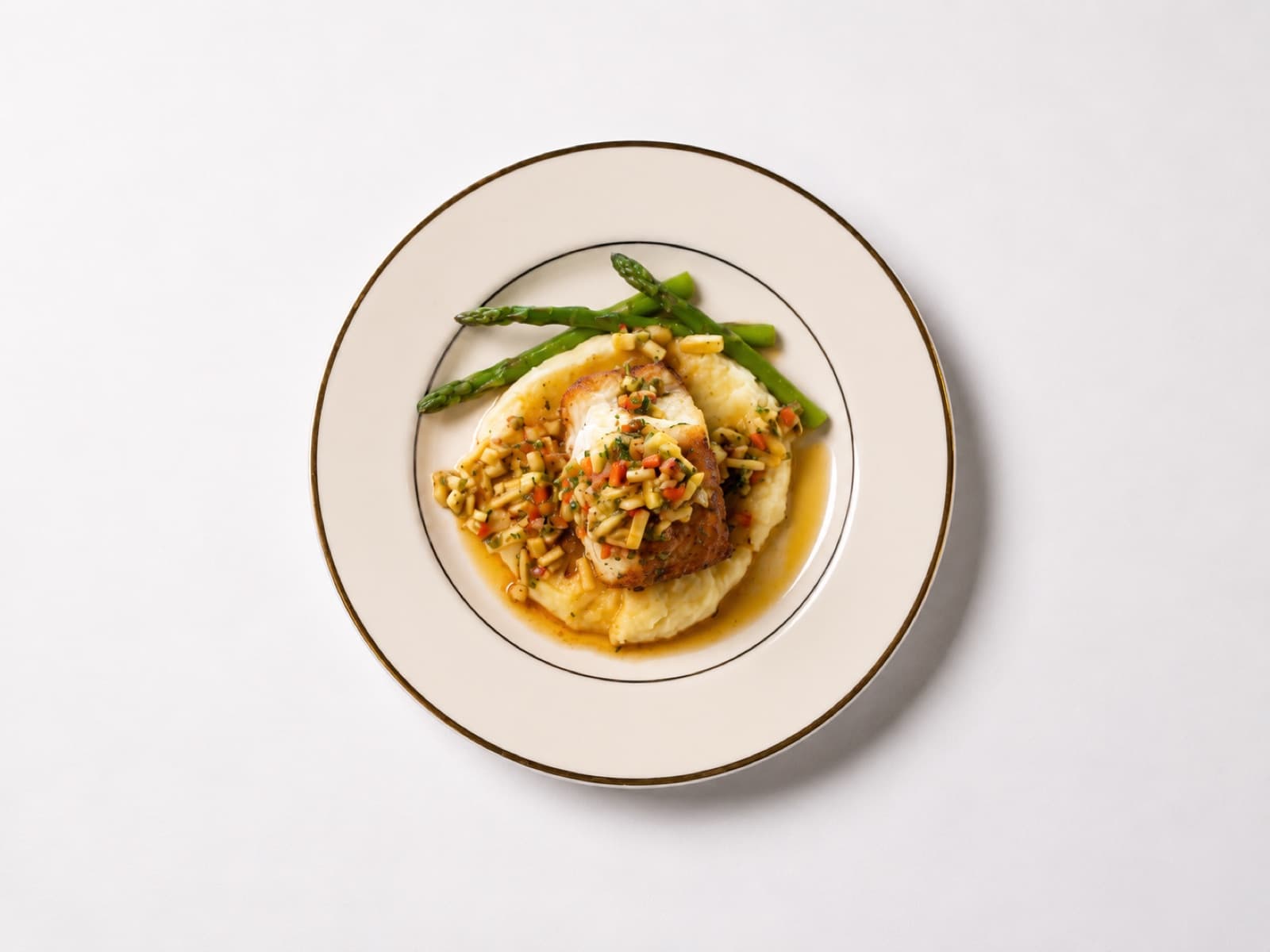 Chicken entrée with grain topping over whipped potato and asparagus