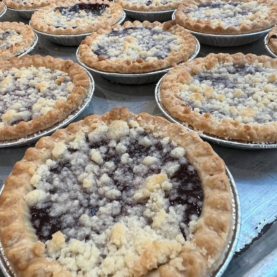 Trays of crumb topped pies